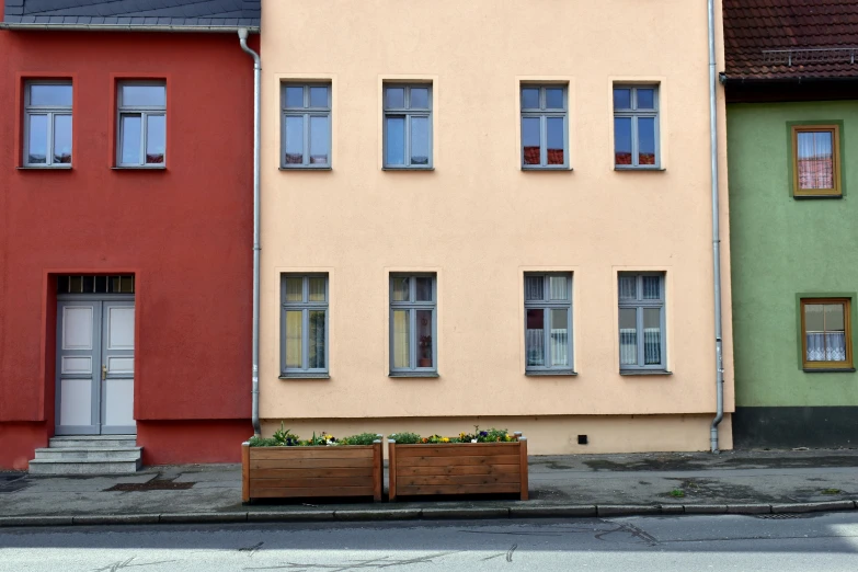 several different colored buildings line a street corner