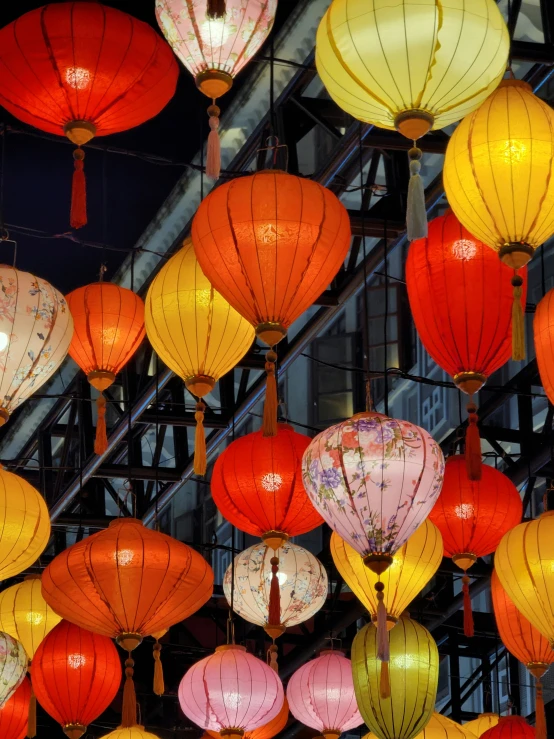 many paper lanterns are hanging from the ceiling