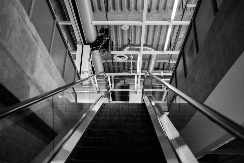 an escalator leading up to a man on the phone