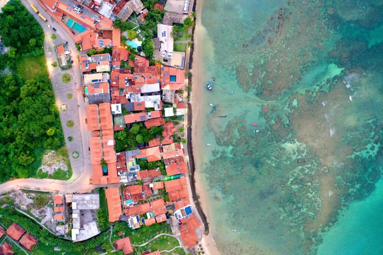 a picture of a beach and many houses with blue water