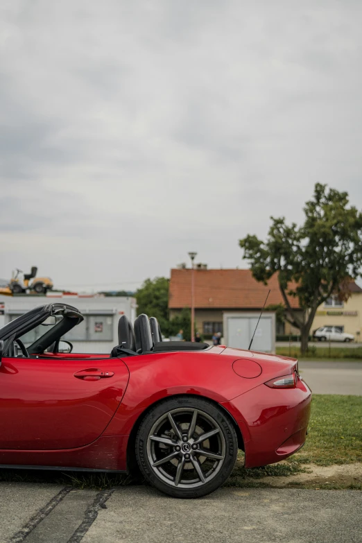 a red sports car parked in front of the street