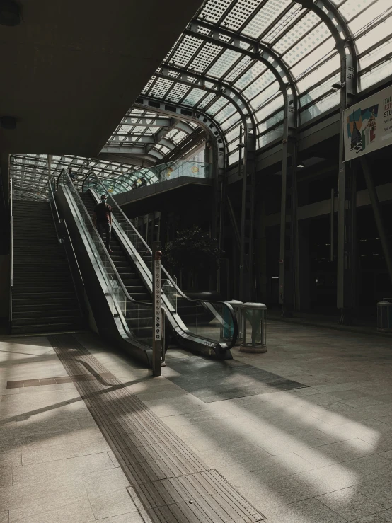 an empty escalator with several passengers climbing it