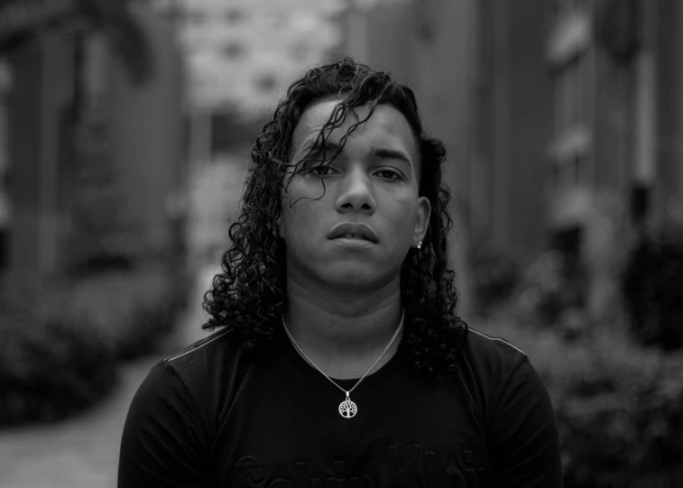 a woman with curly hair, staring to the left