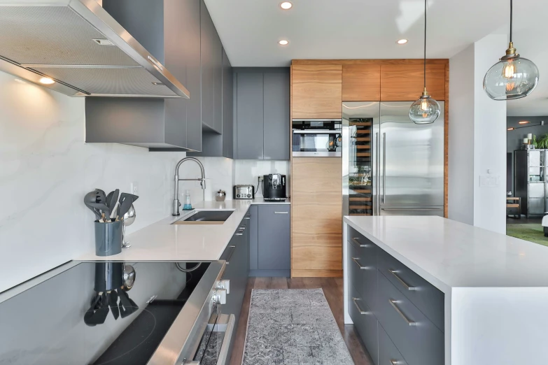 a modern kitchen with stainless steel appliances and wood cabinets