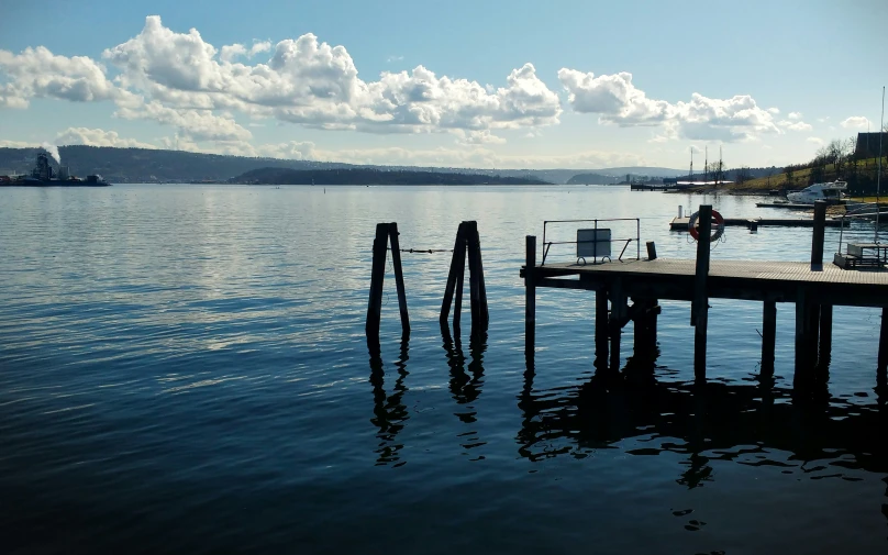 a long dock sitting next to the water