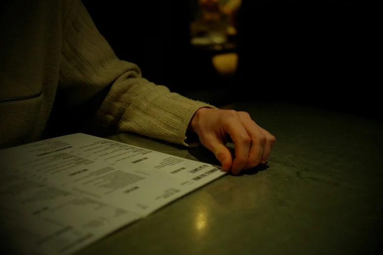 a person with their hand on a paper