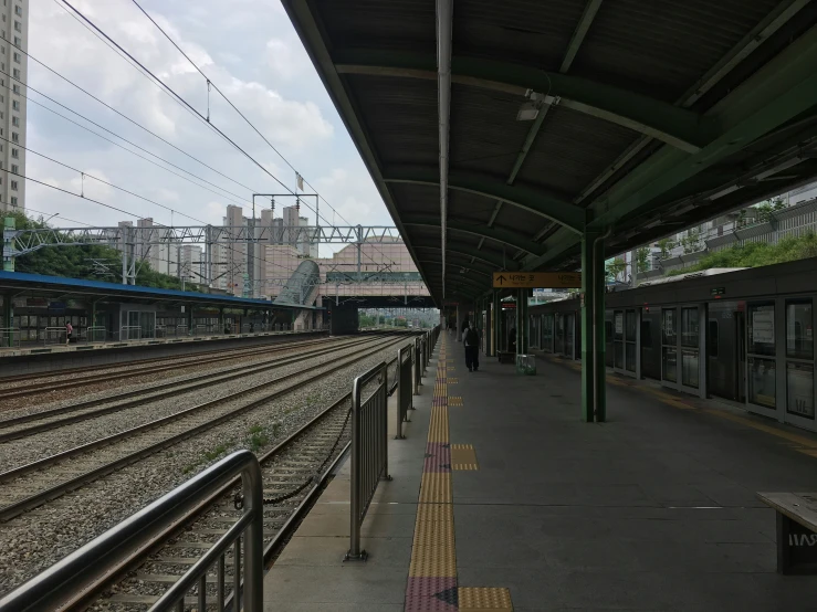 a subway train pulling into the station with several tracks