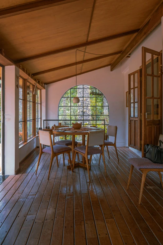 the dining table and chairs are in the porch of the home