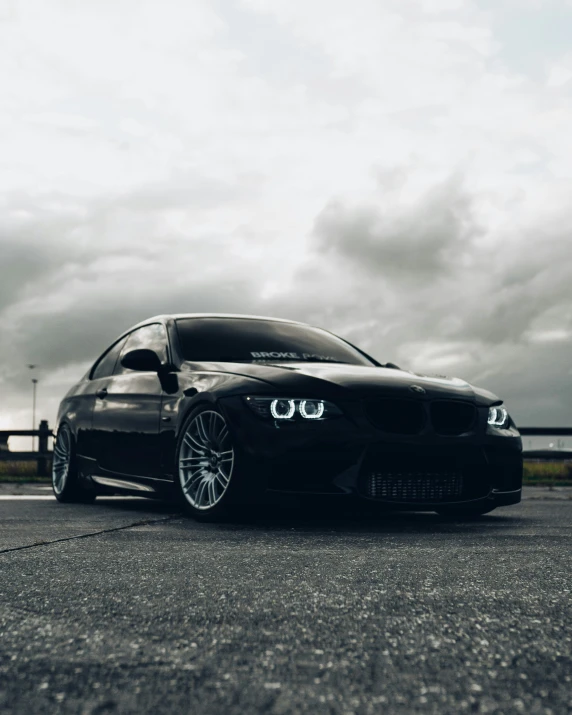 the black sports car is parked on a road