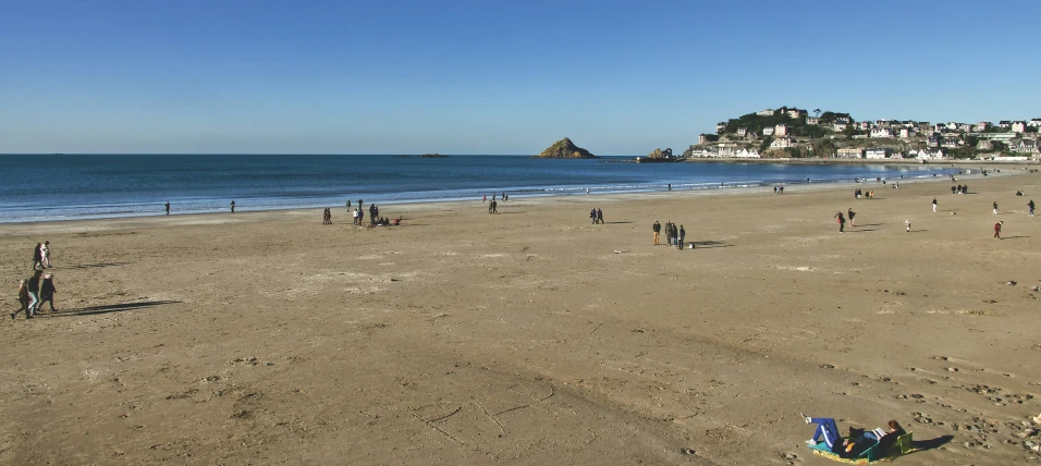 people on the beach and in the ocean