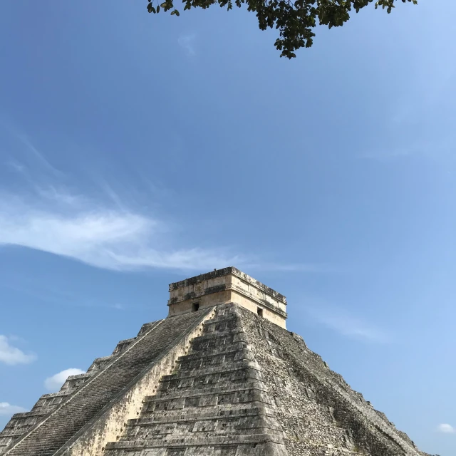 a man is standing near a pyramid in the sky