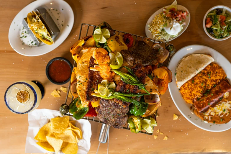 various dishes including potatoes, cornbread, and salsa on a table