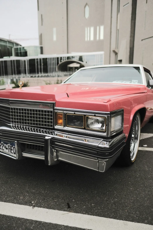 red car parked on top of black asphalt near white lines