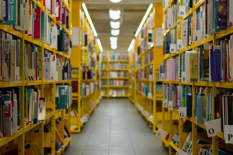 a very large bookshelf with several yellow shelves