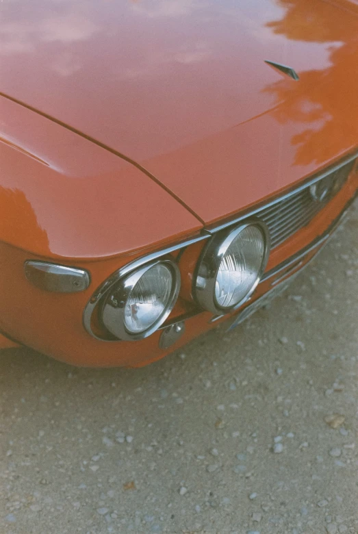 the front of an old vintage red car