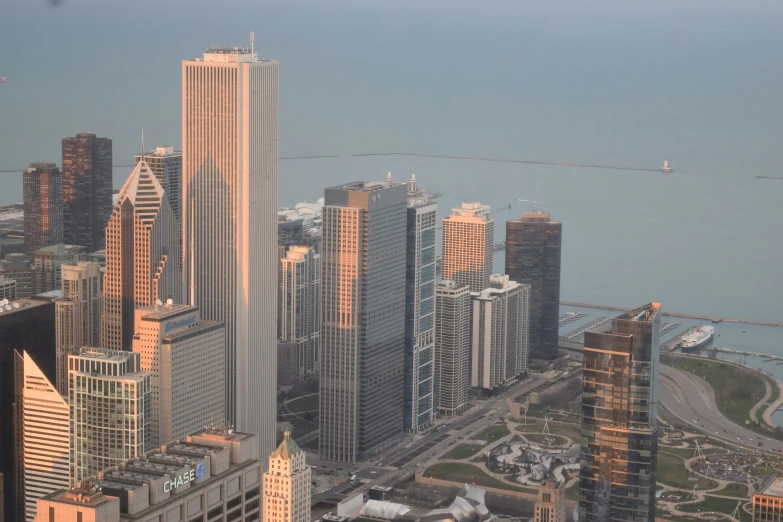 an aerial view of skyscrs on the water