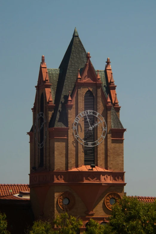 an old building with a clock face and two towers