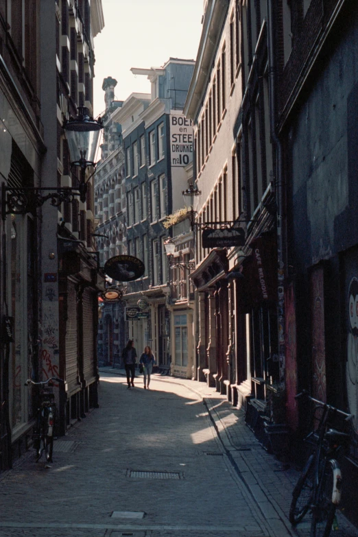 a quiet street lined with tall buildings in a city