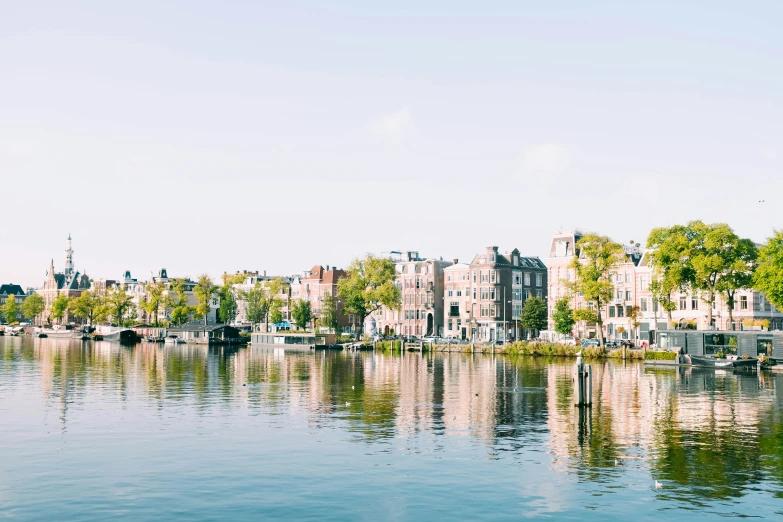 a city next to the water is surrounded by small boats