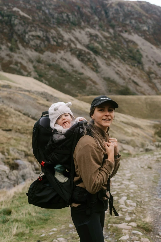 a woman carrying a baby in her back