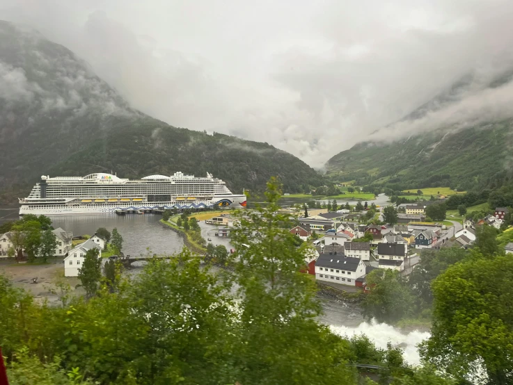 a cruise ship sailing down a river with trees on the banks