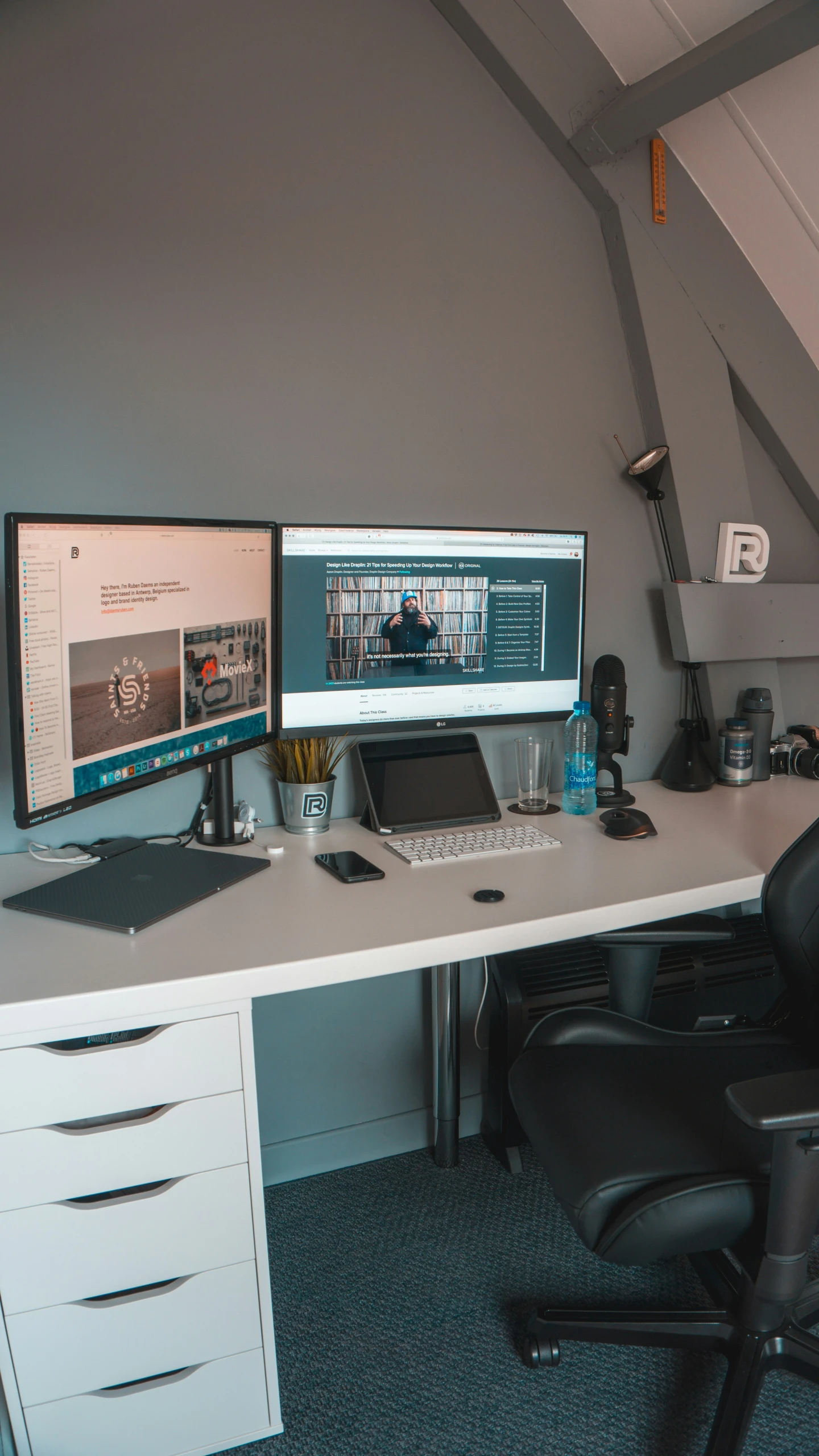 there are two computer monitors sitting on this desk