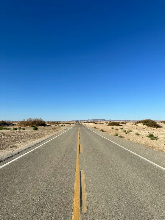 a road with some very thin lines going up the road