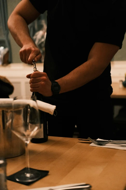 person preparing wine at a glass tasting and serving them
