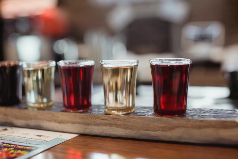 a variety of drinks sit on a bar tray