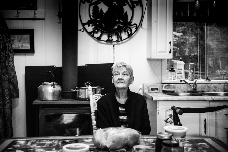 a woman sitting at a table with glasses in front of her