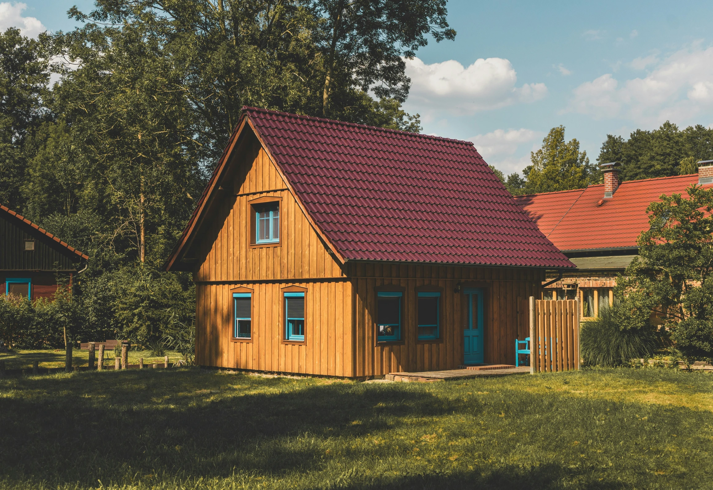 the small house has red tiles on its roof