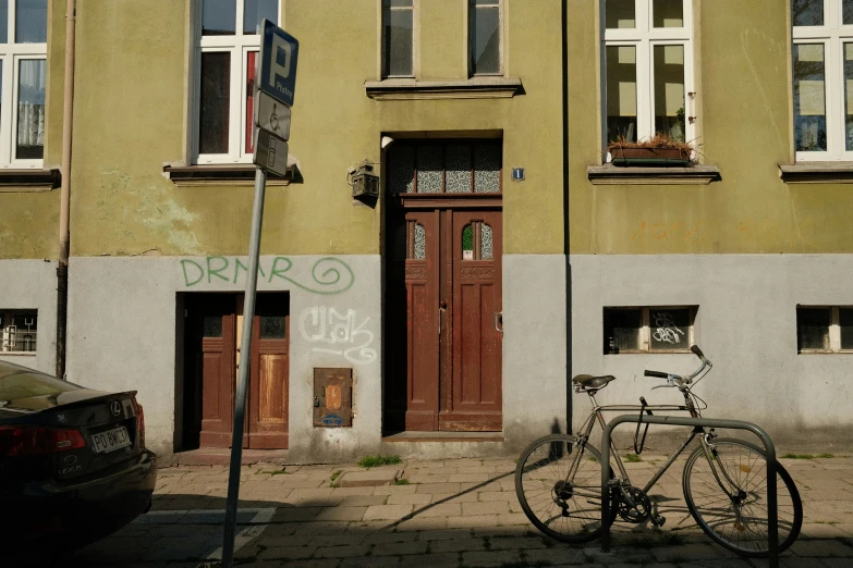 a bike and street signs in front of a large building