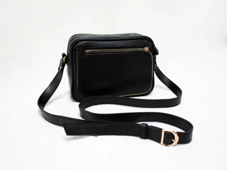 a small black bag is shown with a shoulder strap