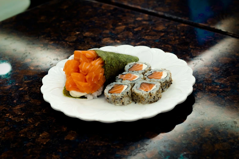 sushi on a white plate on a black table