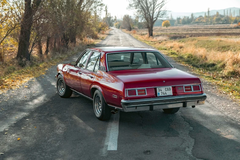 a vintage car parked on a small road