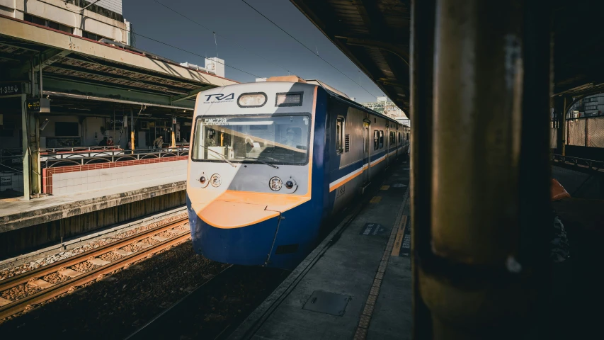 a train is pulling into a station with power lines