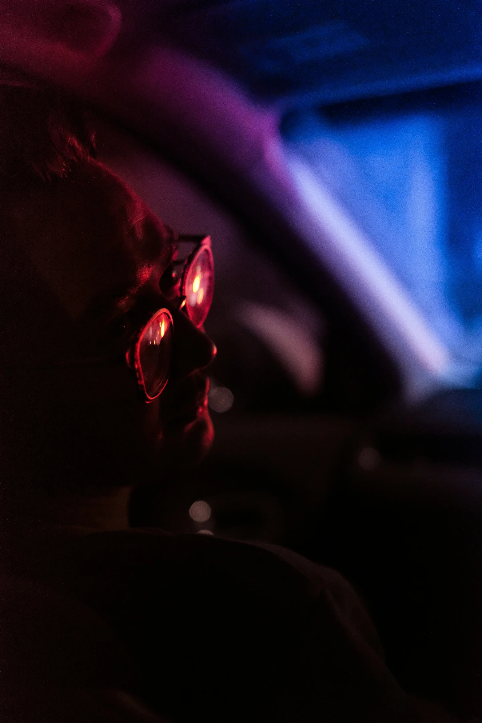 a cat with red eyes wearing red sunglasses