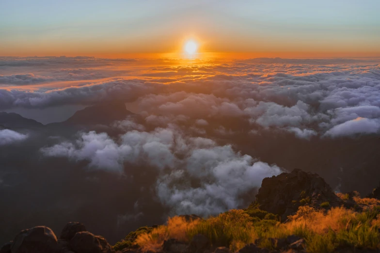 the sun is rising above the clouds of clouds