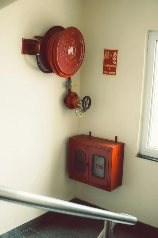a fire extinguisher on a wall in a bathroom