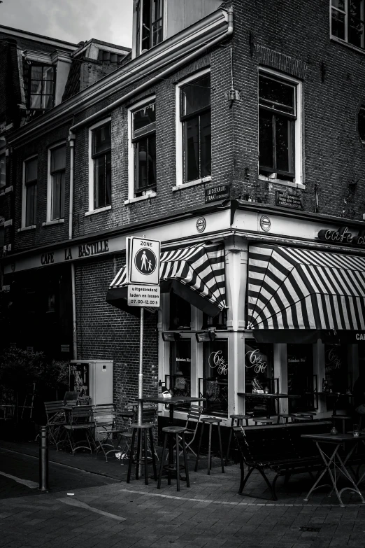 there is a striped awning on the storefront