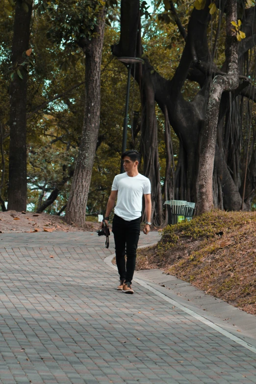 a person on a skateboard is walking by a bench