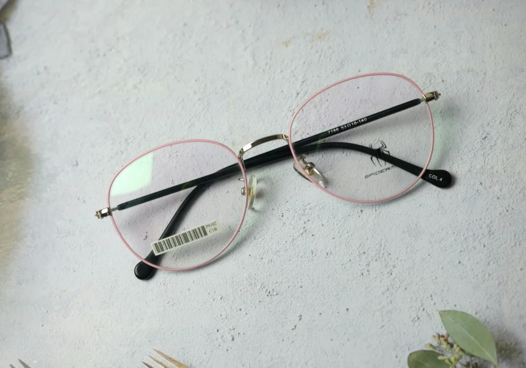 pair of glasses with metal rims lying on cement