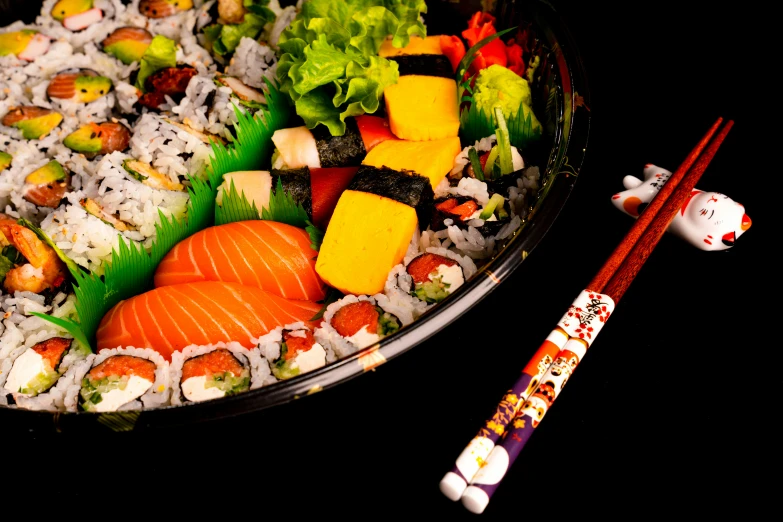 an image of sushi with chopsticks in bowl