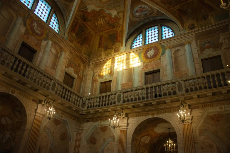 the chandelier in the ornate building is lit