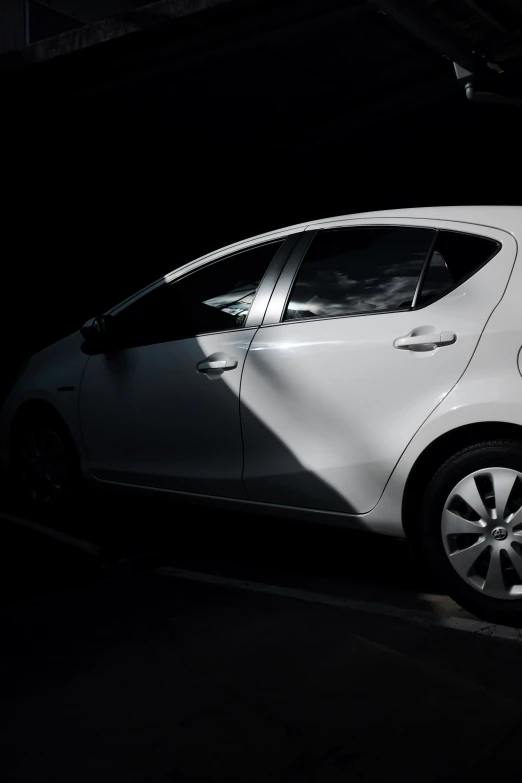 white car in parking lot with a dark background