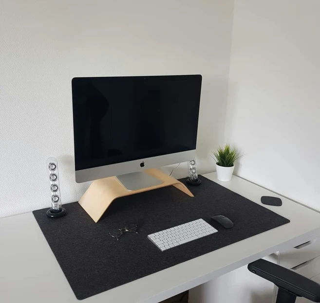 an empty desk with a computer and speakers