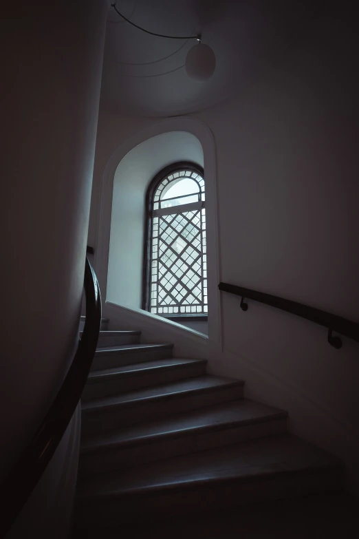 the staircase leading to a big glass window