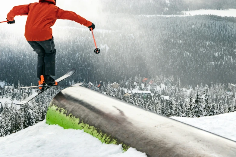 person wearing skis jumping over the edge of a ramp