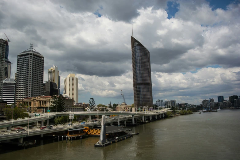 a city scene with tall buildings and cloudy skies