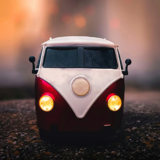 a car with its lights on sitting in a parking lot